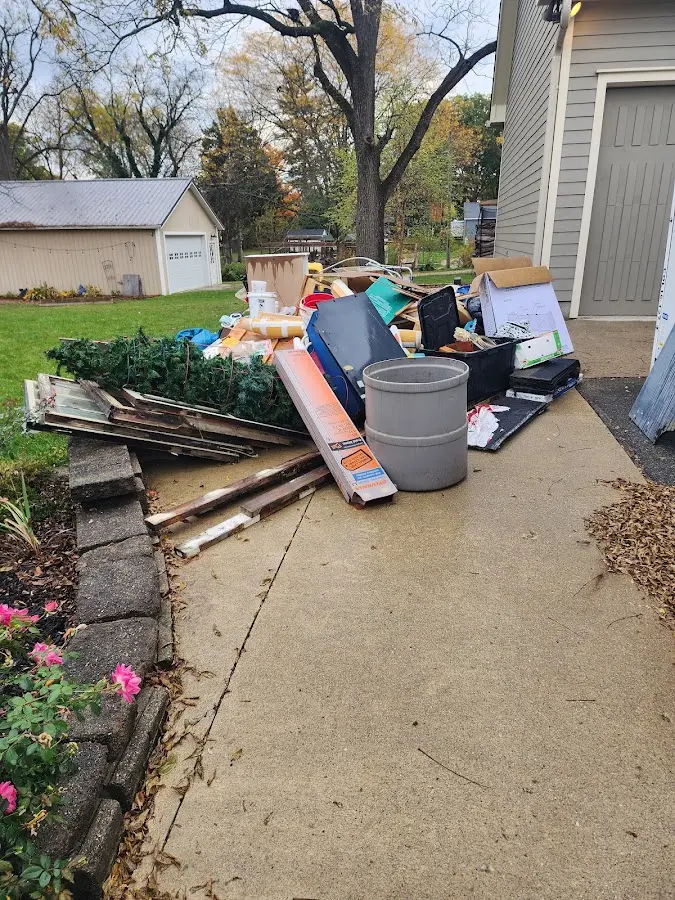Dumpster being loaded with debris for 12 Yard Dumpster Rental in Detroit Lakes